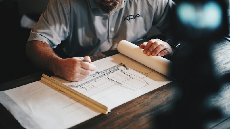 Designer reviewing detailed plans and visual concepts